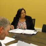 Ms. Jamison at work in a Legal Aid board meeting.